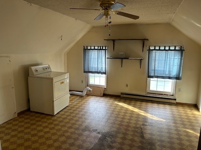 bonus room featuring washer / dryer, vaulted ceiling, a textured ceiling, and ceiling fan