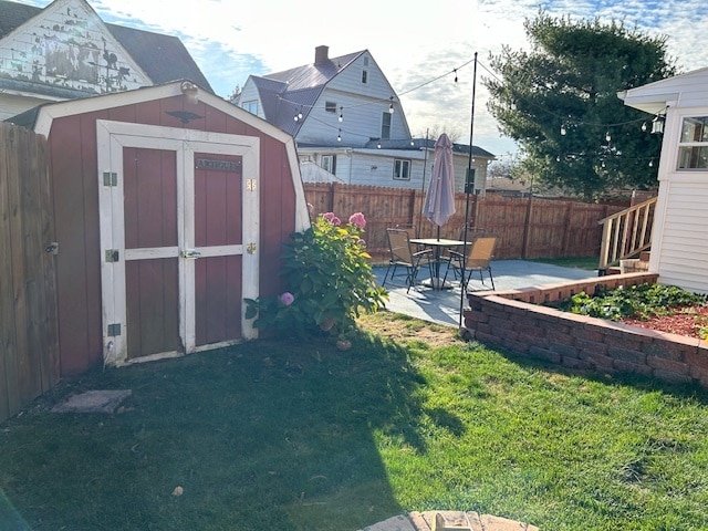 view of yard featuring a patio and a storage shed