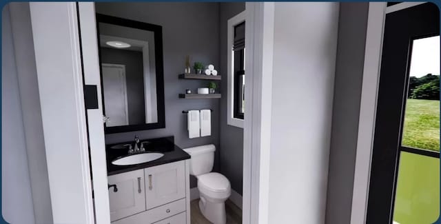 bathroom featuring vanity and toilet