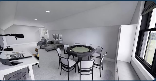 carpeted dining room featuring vaulted ceiling