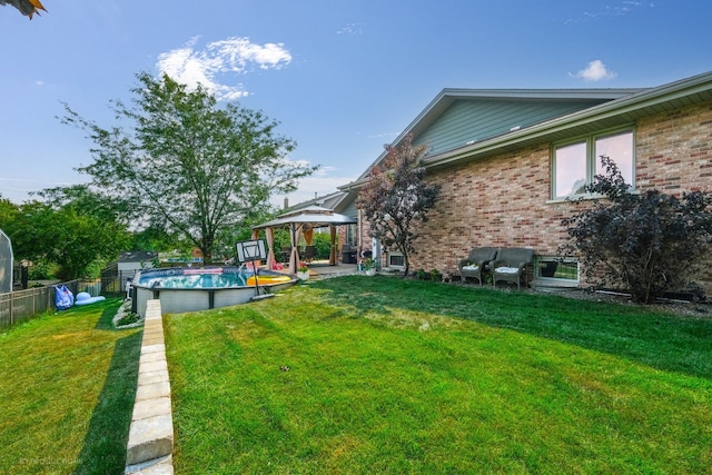 view of yard with a fenced in pool and a gazebo