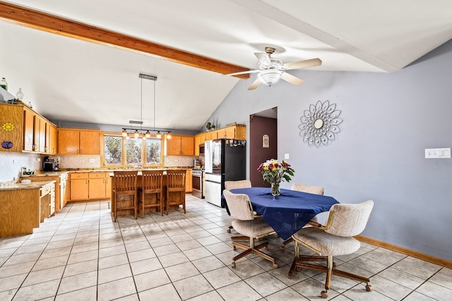 dining room with lofted ceiling with beams, ceiling fan, and light tile patterned floors