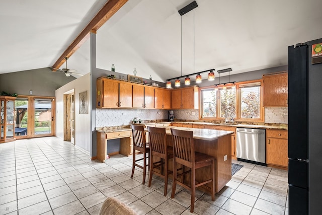 kitchen with ceiling fan, stainless steel dishwasher, backsplash, and black fridge