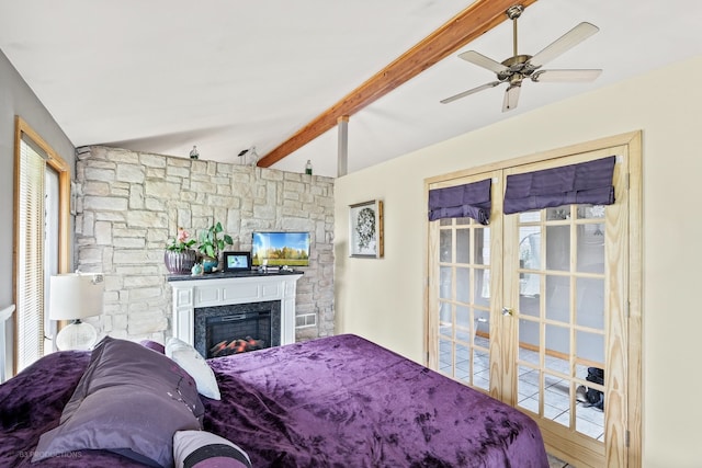 bedroom with ceiling fan, lofted ceiling with beams, and multiple windows