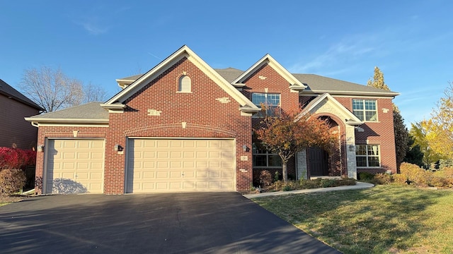 view of front of property featuring a garage and a front lawn