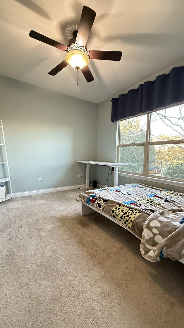 unfurnished bedroom featuring carpet and ceiling fan