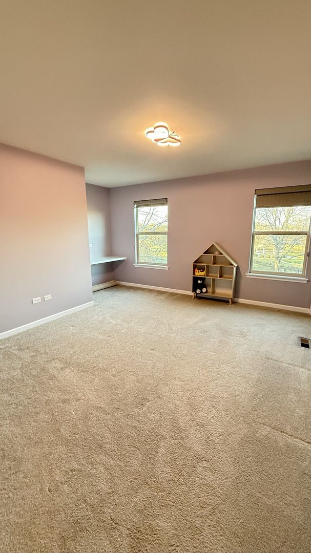 empty room with carpet floors and plenty of natural light