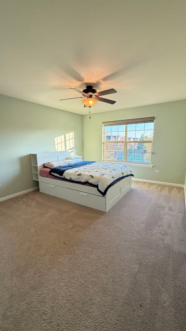 unfurnished bedroom with carpet floors and ceiling fan