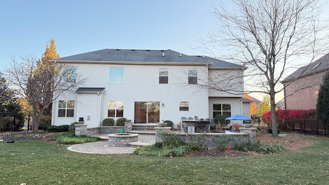 back of house featuring a patio and a lawn