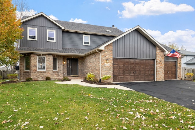 view of front of home featuring a front yard and a garage