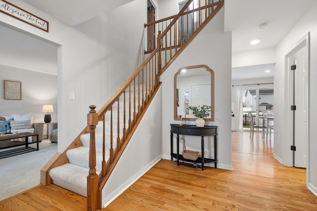 stairway featuring wood-type flooring