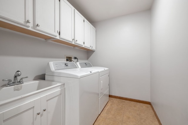 washroom with cabinets, independent washer and dryer, light tile patterned floors, and sink