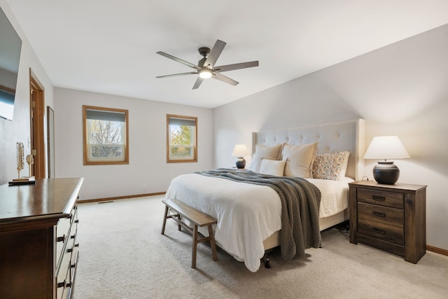 bedroom featuring light colored carpet and ceiling fan