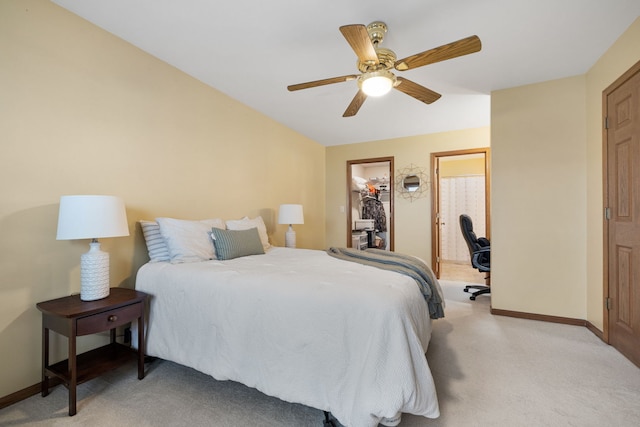 bedroom with a walk in closet, ceiling fan, and light colored carpet