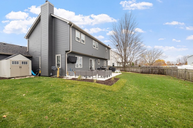 back of house featuring outdoor lounge area, a storage unit, a patio, and a lawn