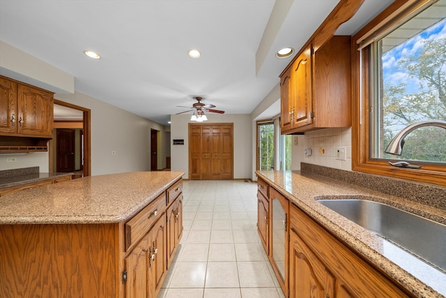 kitchen with plenty of natural light, sink, tasteful backsplash, and ceiling fan