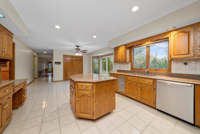 kitchen with backsplash, light tile patterned floors, sink, dishwasher, and a center island