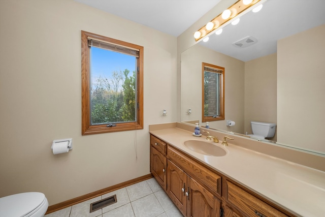 bathroom featuring toilet, vanity, and tile patterned flooring