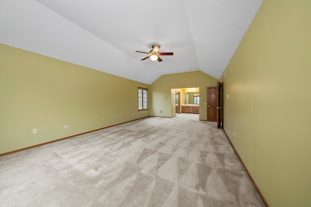 unfurnished living room with lofted ceiling, light carpet, and ceiling fan