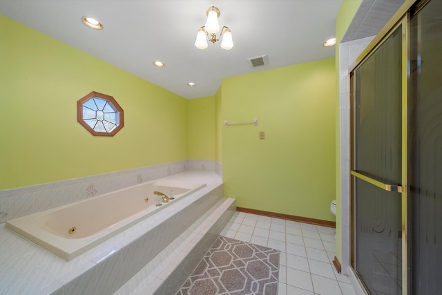 bathroom featuring toilet, tile patterned flooring, and tiled tub