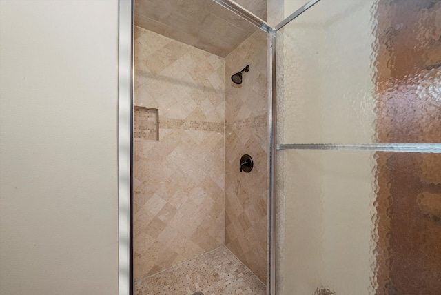 bathroom featuring a shower with door