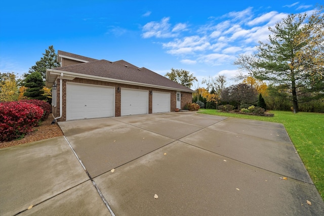 view of property exterior with a garage and a yard