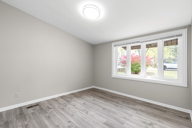 empty room with light hardwood / wood-style flooring