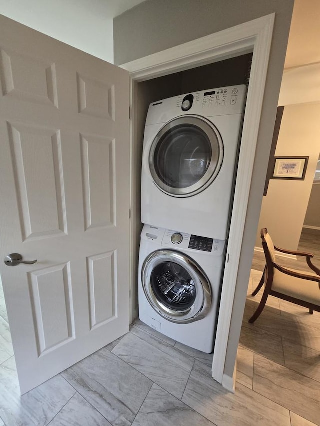 laundry room featuring stacked washer / drying machine