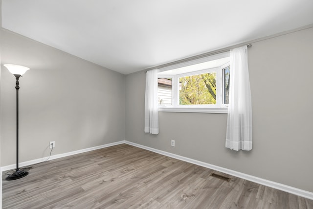 spare room with light hardwood / wood-style floors