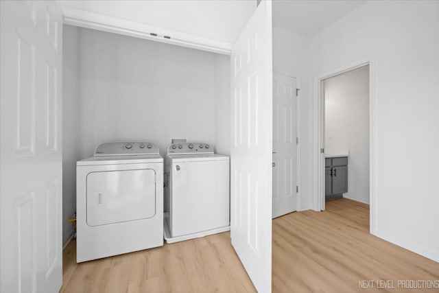 washroom featuring separate washer and dryer and light wood-type flooring