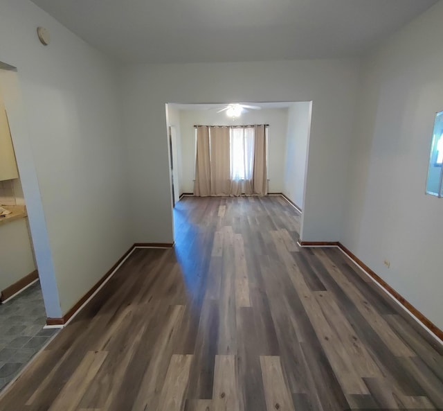 spare room featuring ceiling fan and dark hardwood / wood-style flooring