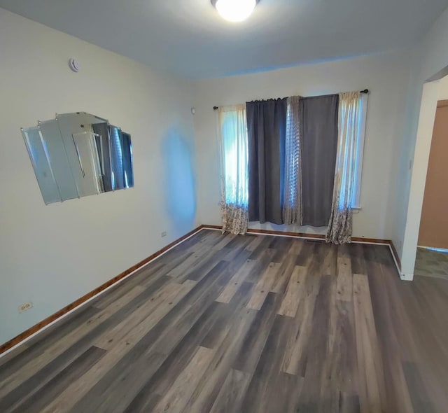 unfurnished room featuring dark hardwood / wood-style flooring