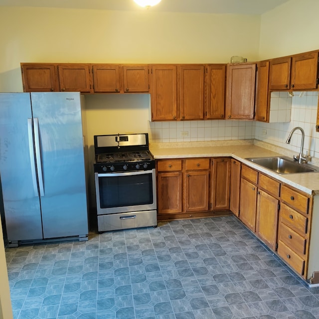 kitchen with tasteful backsplash, sink, and stainless steel appliances