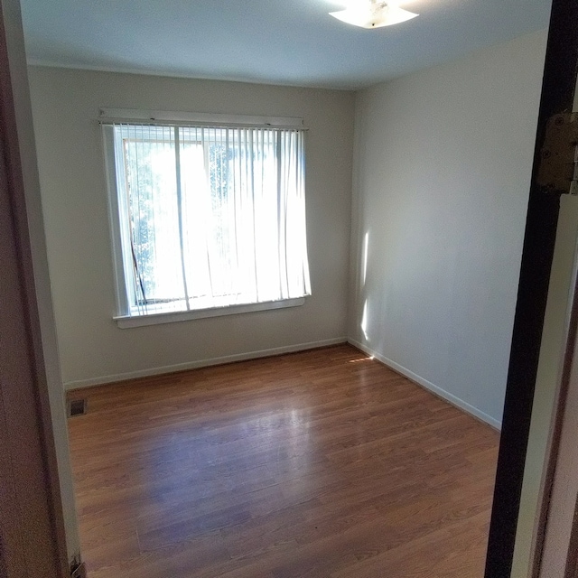 empty room featuring hardwood / wood-style flooring