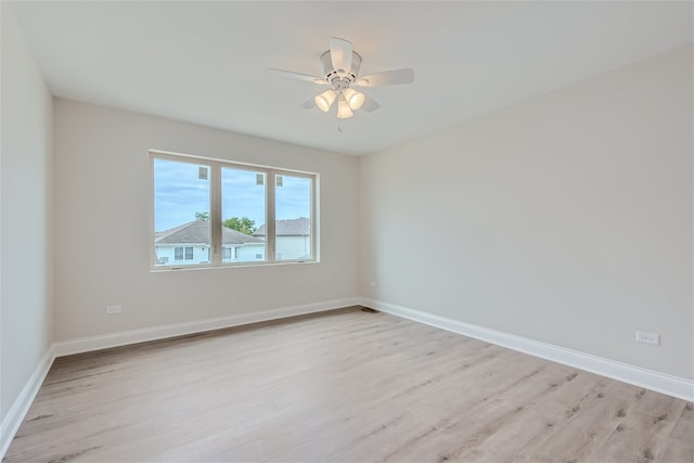 empty room with light hardwood / wood-style floors and ceiling fan