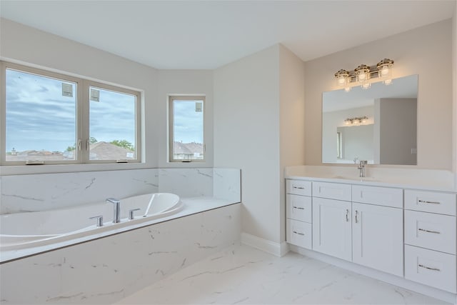 bathroom with vanity and a tub