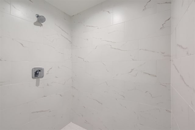 bathroom with a tile shower