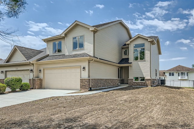 view of front of home featuring central AC unit and a garage