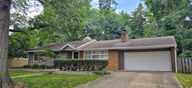 single story home featuring a front lawn and a garage