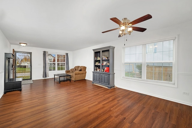 unfurnished room with dark wood-type flooring and ceiling fan