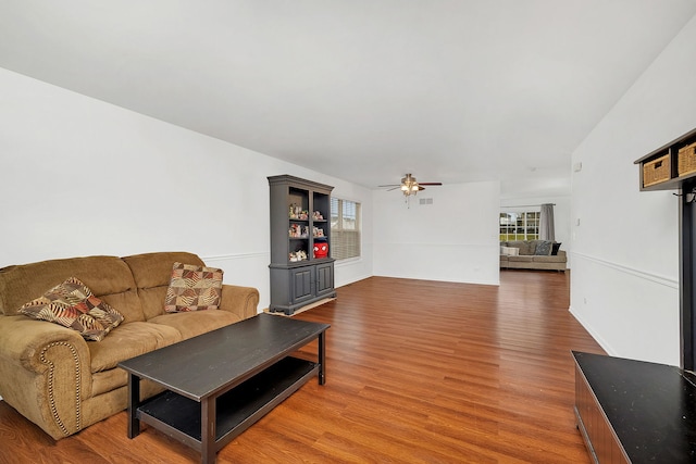 living room featuring hardwood / wood-style flooring and ceiling fan