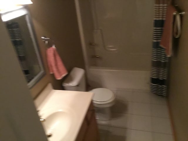 full bathroom featuring tile patterned floors, vanity, toilet, and shower / tub combo