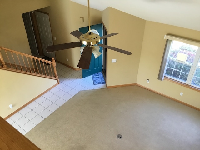 unfurnished living room with light tile patterned floors and ceiling fan