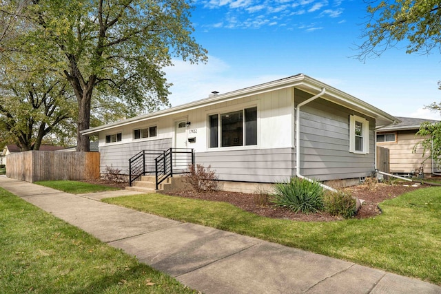 ranch-style home with a front lawn