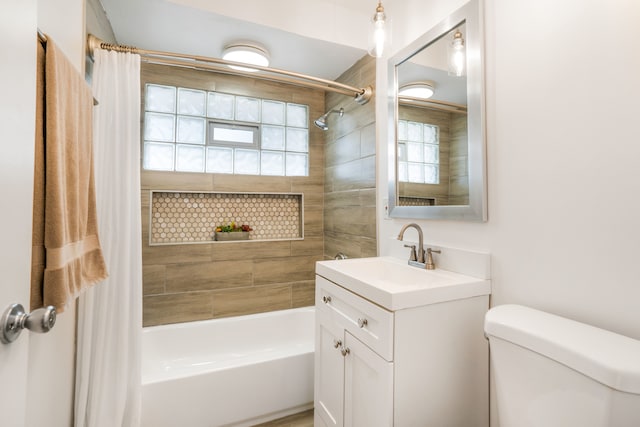 full bathroom with vanity, toilet, a healthy amount of sunlight, and shower / bath combo