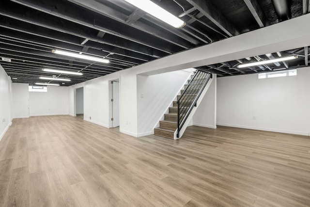 basement with hardwood / wood-style floors