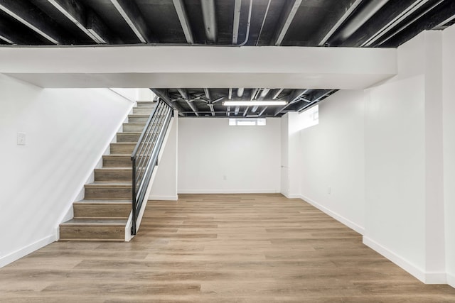 basement with hardwood / wood-style flooring