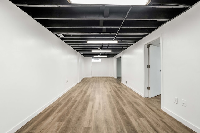 basement with hardwood / wood-style floors