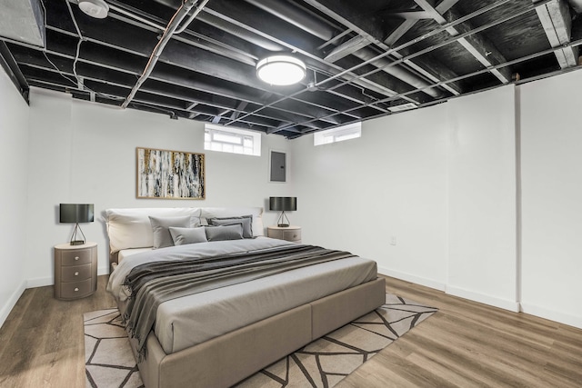 bedroom featuring wood-type flooring and electric panel