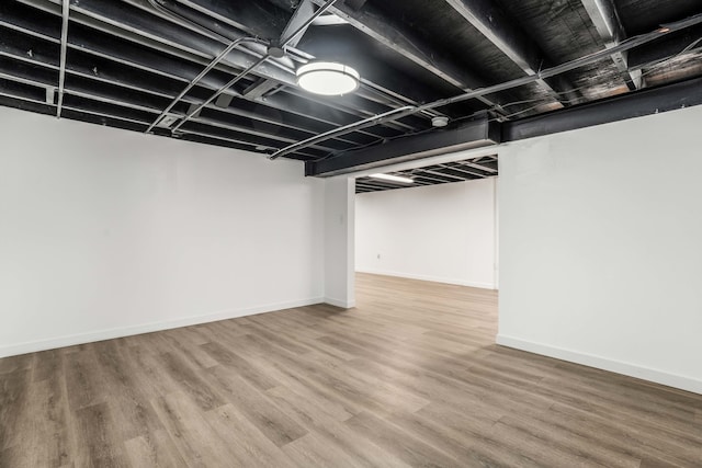 basement with hardwood / wood-style flooring